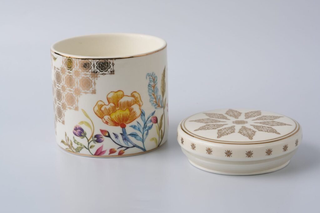 Casa Aseana porcelain candle with its gold-detailed lid set beside it