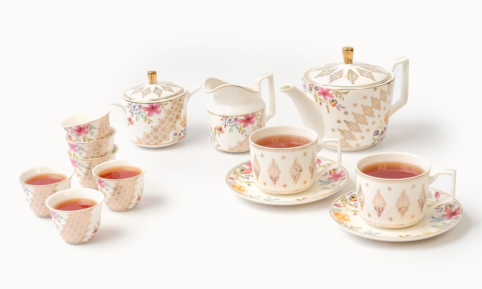 Casa Aseana fine porcelain teapot set, teacups and saucers and small cups served with tea
