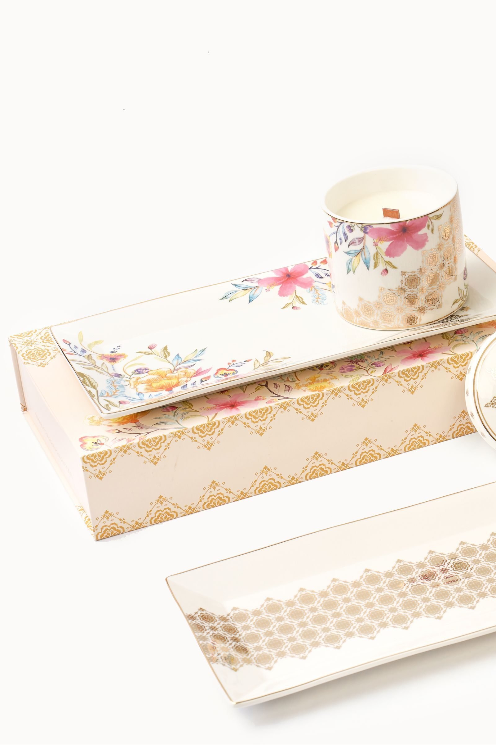 The Casa Aseana Serving Plate, Bunga Raya on its gift box with the Porcelain Candle, beside the Serving Plate, Songket