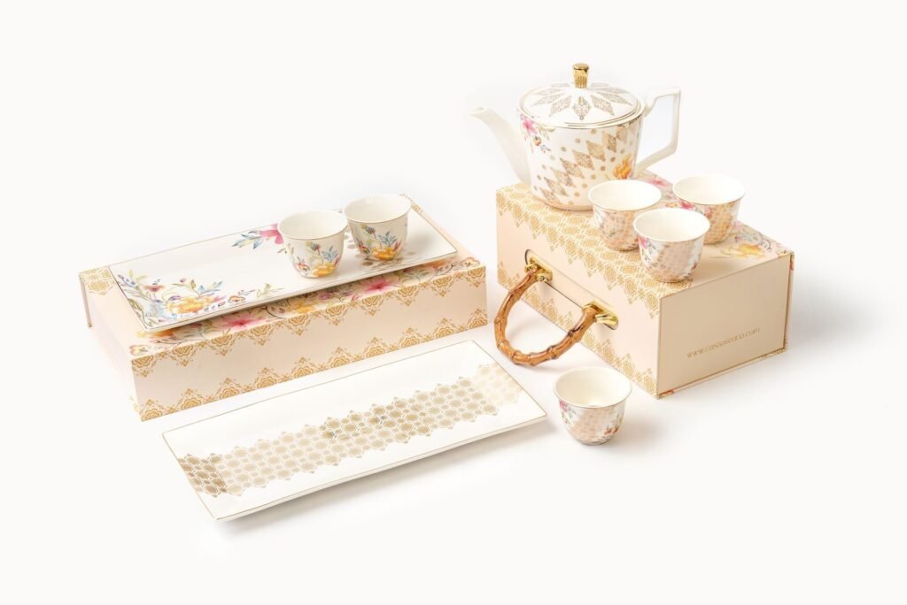 Set of six Casa Aseana small porcelain cups with gold detailing, displayed on gift boxes