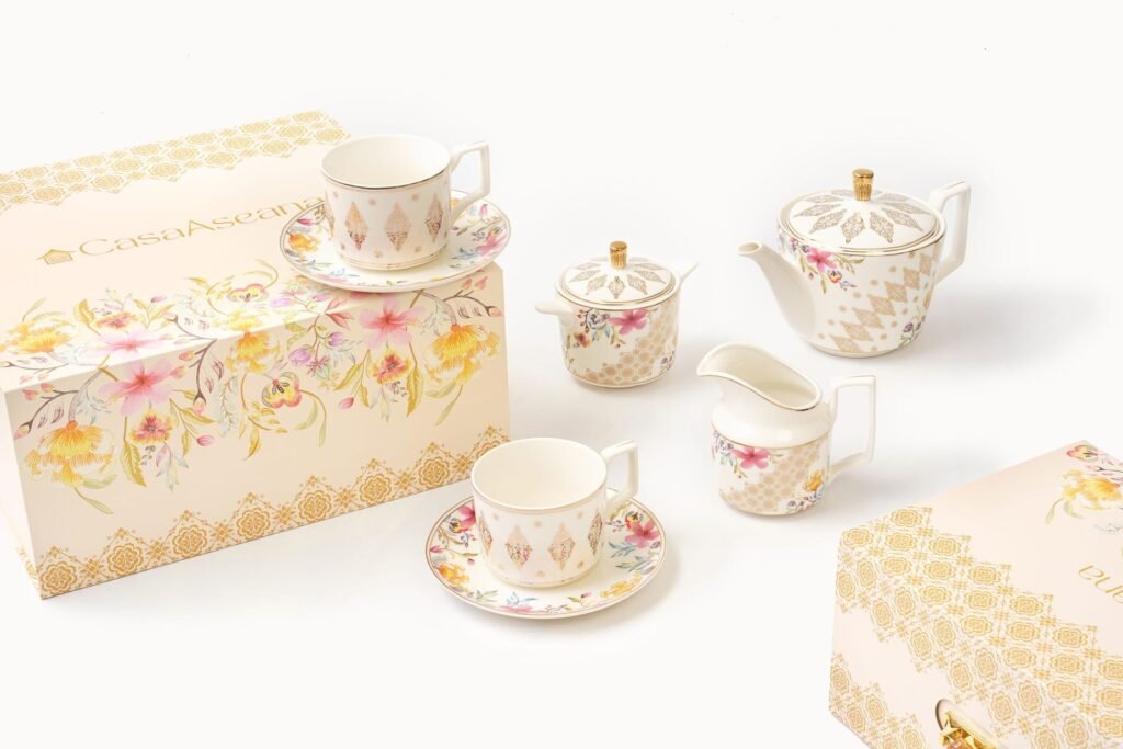 Casa Aseana porcelain teacups and saucers with gold detailing, displayed with gift boxes